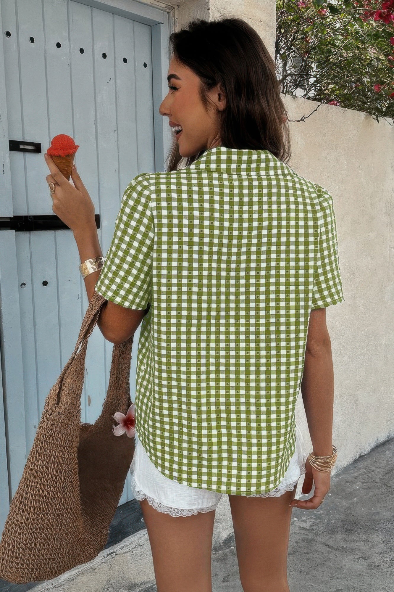 CCWHOLESALECLOTHING model back view wearing women’s plaid button down shirt green gingham short sleeve with tote and ice cream