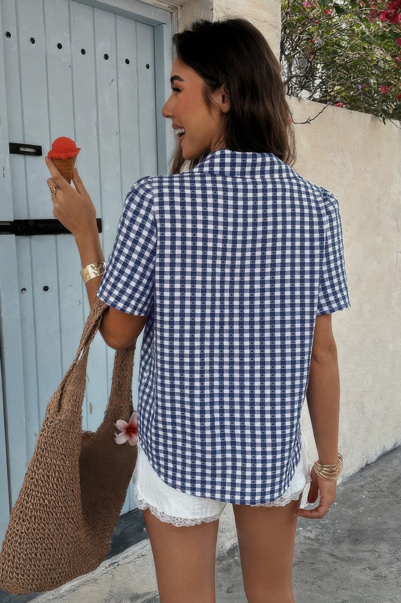 Woman wearing CCWHOLESALECLOTHING women’s plaid button down shirt blue gingham short sleeve with straw tote