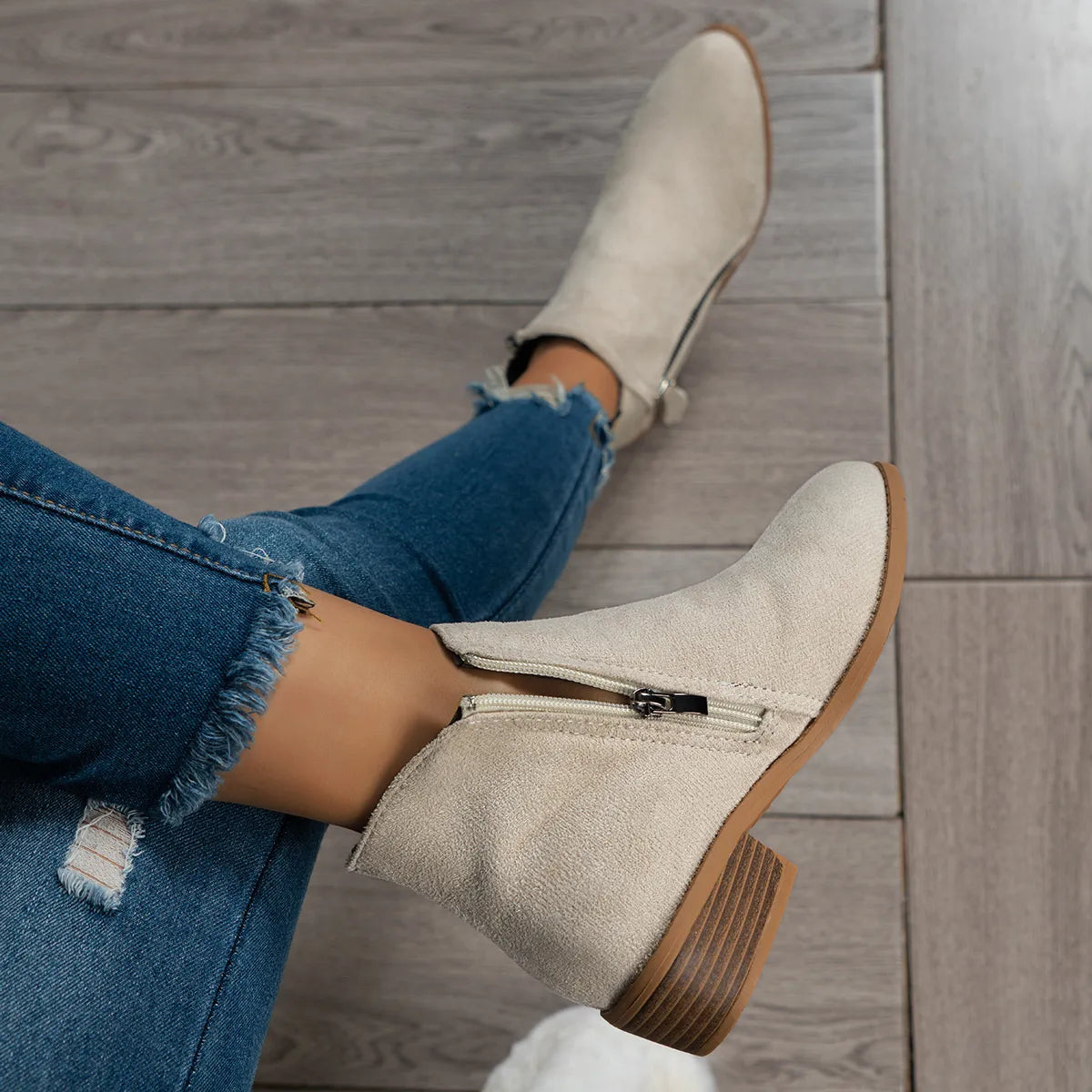 Trendsi women's side zip ankle boots in beige suede with low stacked heel styled with frayed hem jeans