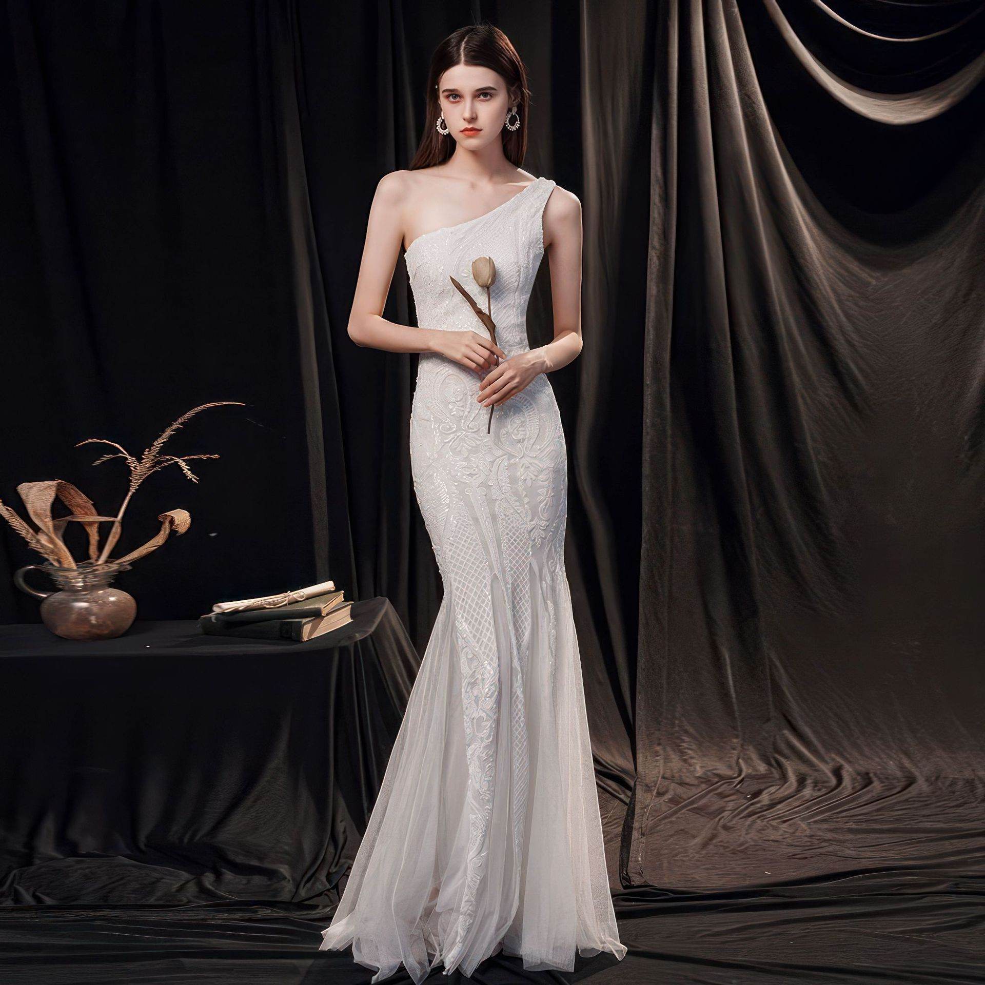 Beautiful model wearing a Slimming Fishtail Wedding Dress with a one-shoulder design and elegant lace detailing