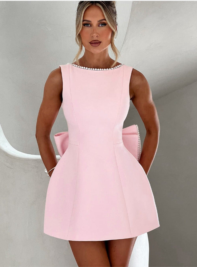CJ Solid Color Mini Dress in Pink with Elegant Bow Detail and Pearl Trim for Stylish Occasions