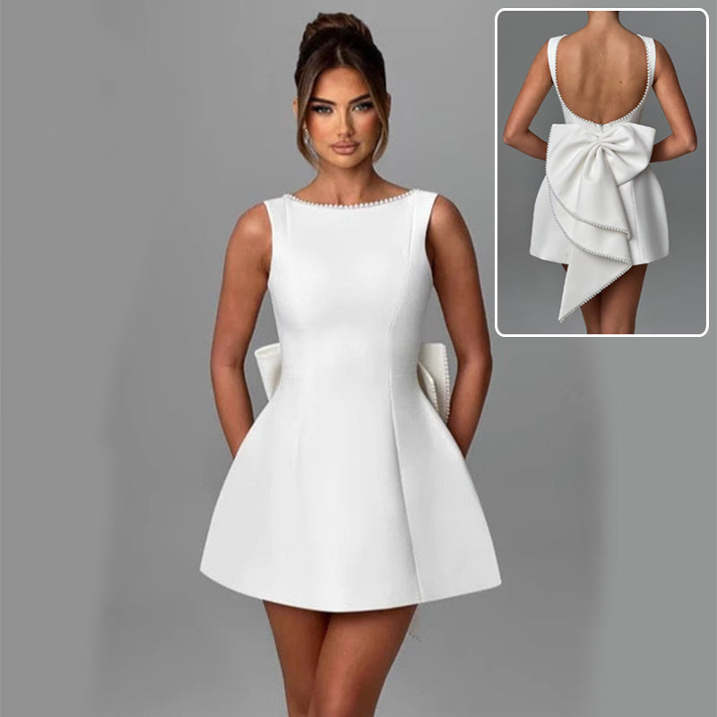 Solid Color Mini Dress in white with a stylish back bow and flared skirt for a chic look