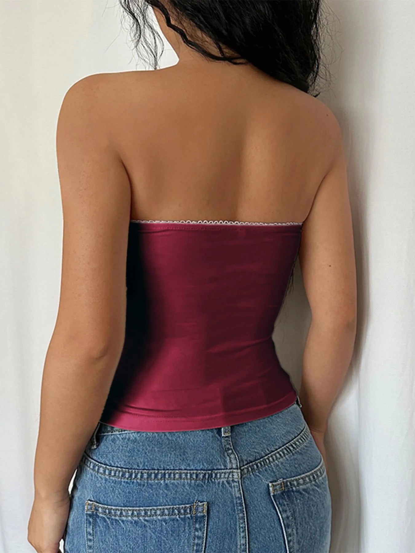 Back view of a burgundy Strapless Tube Top paired with high-waisted denim shorts
