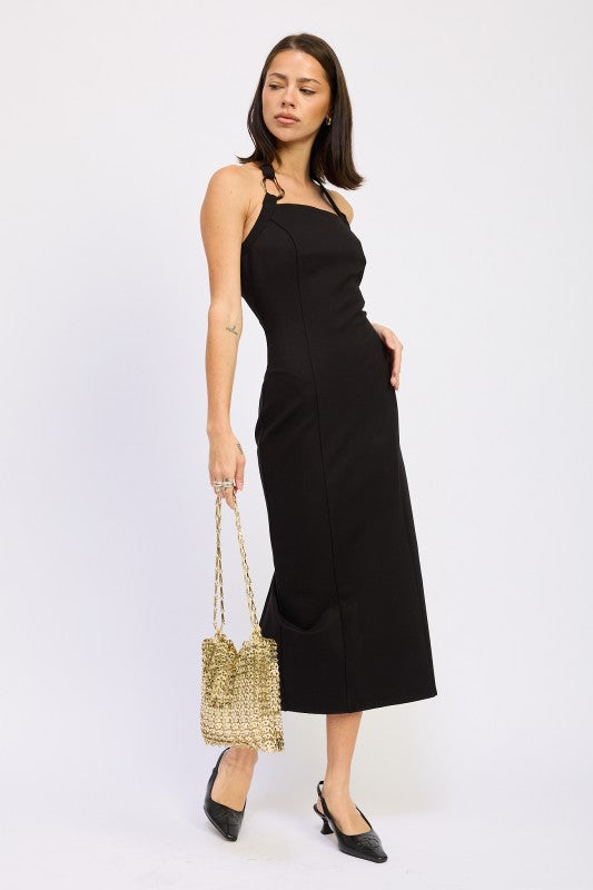 Emory Park black sleeveless open back midi dress on model with knot shoulder straps and gold beaded bag