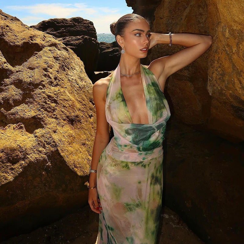 Woman modeling a Stylish Tie-Dye Maxi Dress against a rocky background in natural light