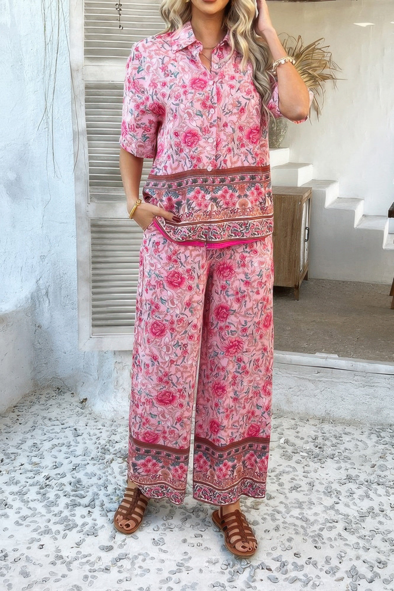 Woman wearing pink floral Boho Blouse Pant Sets with button front short sleeve top and wide leg pants