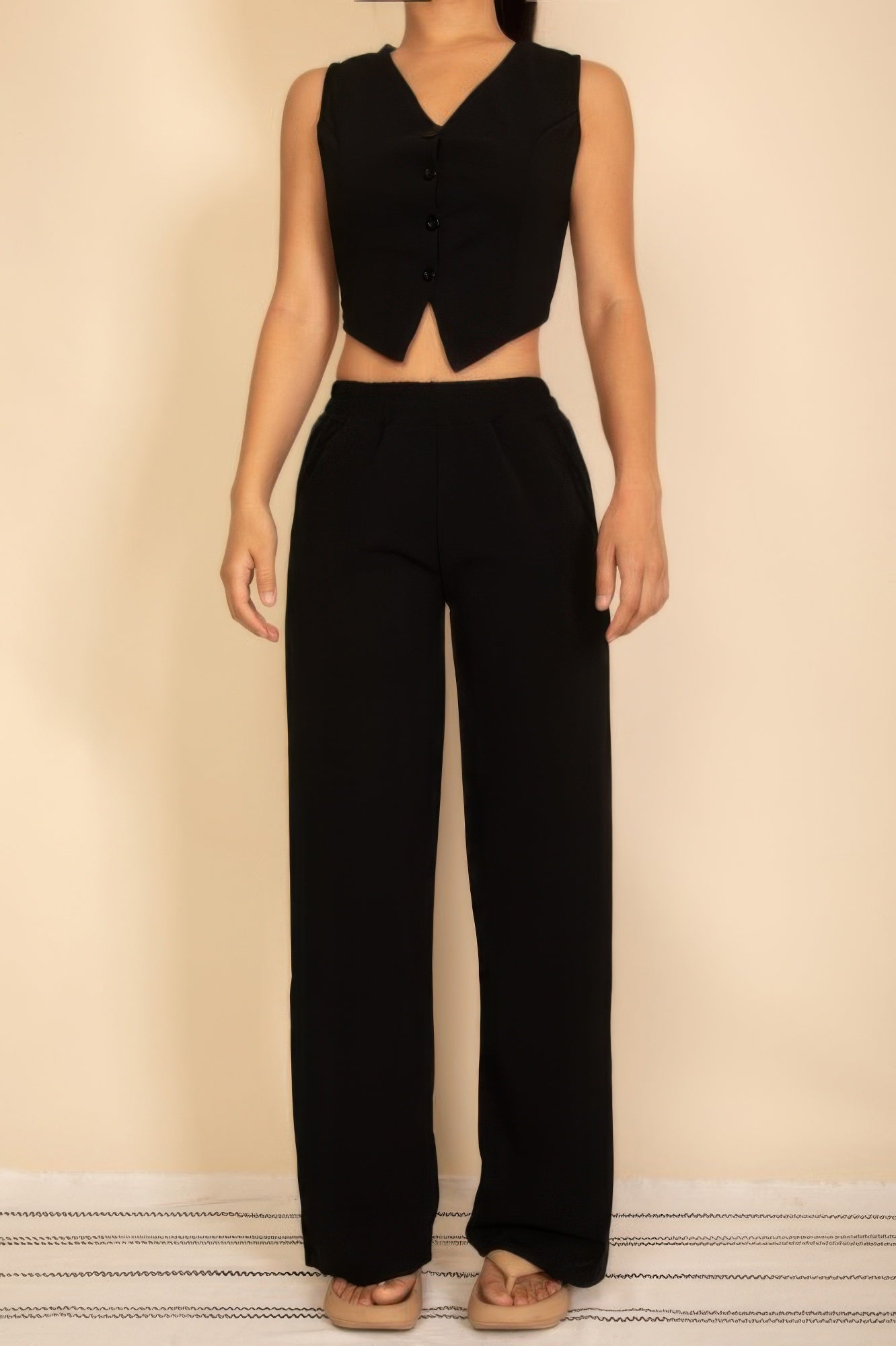 Chic black tailored button vest paired with matching wide-leg pants for a stylish look