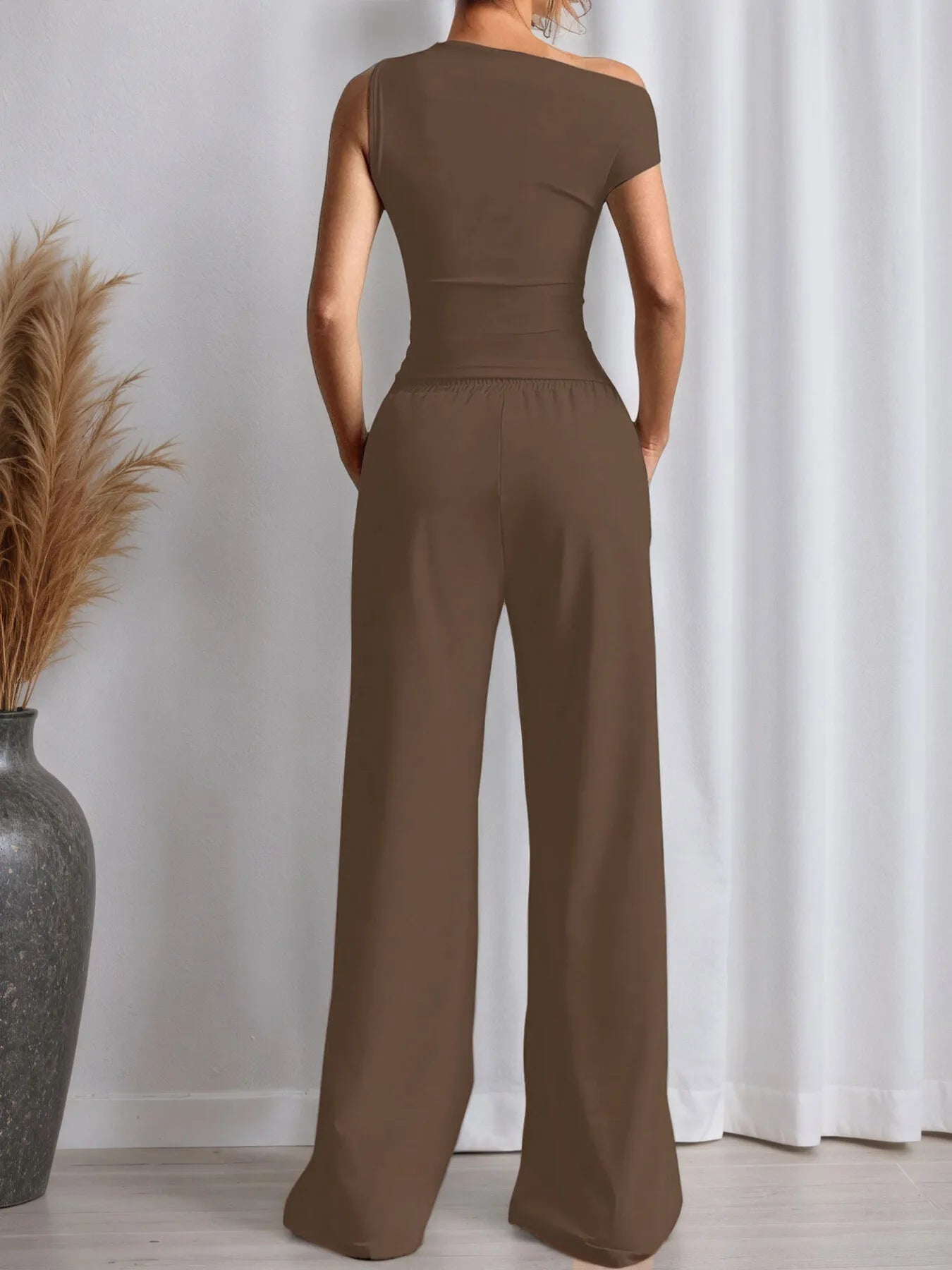 Brown apparel featuring a fitted top with trendy pants for a stylish look