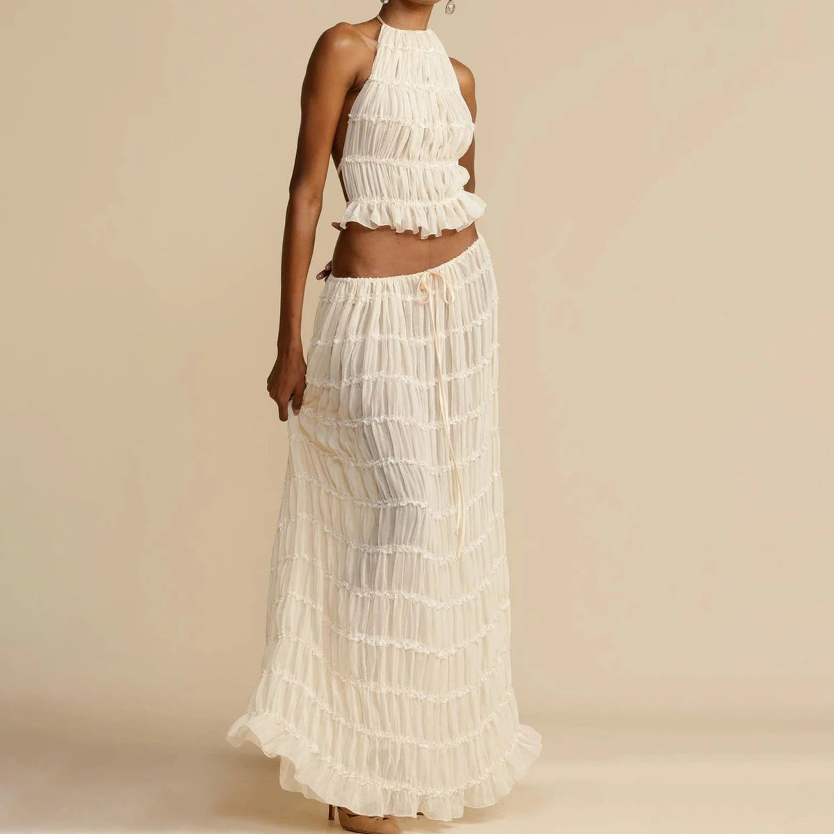 Model wearing a Trendy Halter Top & Maxi Skirt in cream with a flowing, chic design