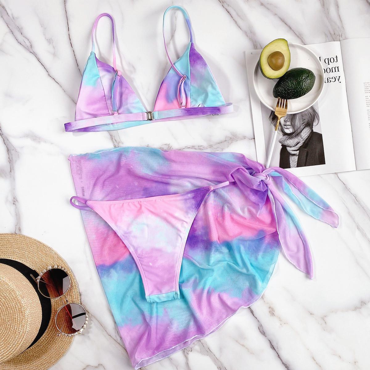 Trendsi triangle micro bikini set in pastel tie-dye colors with matching sarong on marble surface