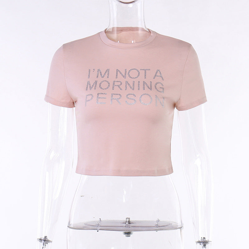 Trendsi pink Crop T-Shirt with I AM NOT A MORNING PERSON silver glitter slogan cropped short sleeve crewneck on mannequin