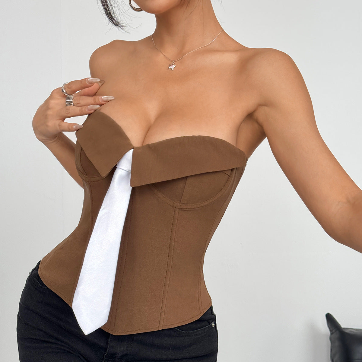 Trendsi brown corset strapless Y2K bandeau top with white tie detail modeled with black jeans