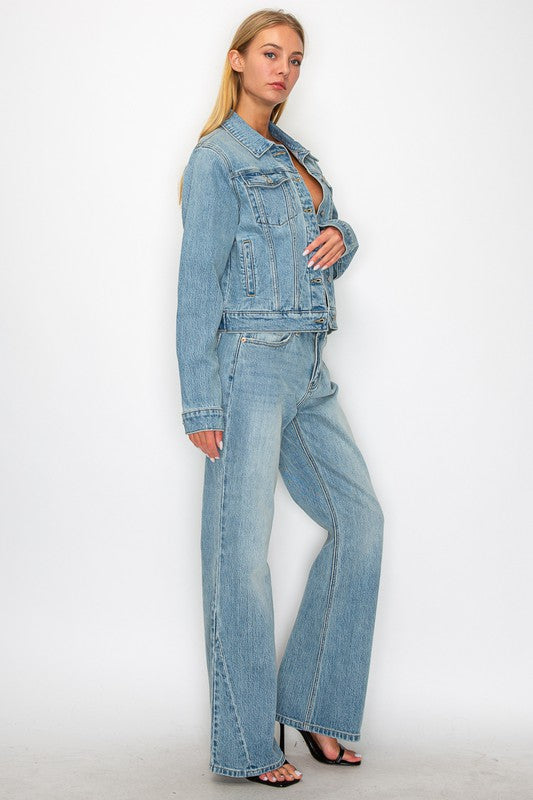 Artemis Vintage model wearing light wash women's mid rise flare jeans with matching denim jacket and heeled sandals
