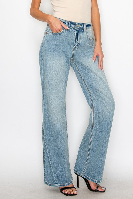 Artemis Vintage light wash women's mid rise flare jeans modeled with cream tank and black heels