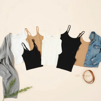 Neatly styled camis and tanks in neutral tones layered with a cardigan and denim jacket