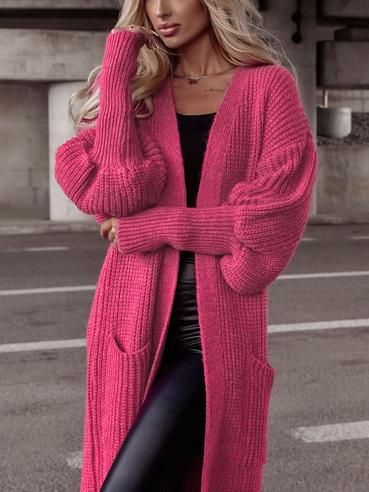 Woman in long chunky pink cardigan over black top and leather leggings for the Art of Fall Fashion layering
