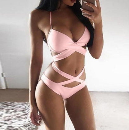 Person wearing a pink bikini taking a mirror selfie.