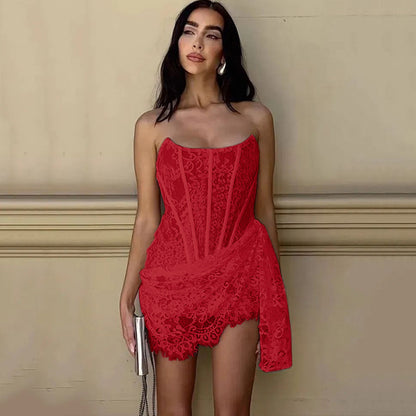 Woman wearing a red lace dress against a beige wall