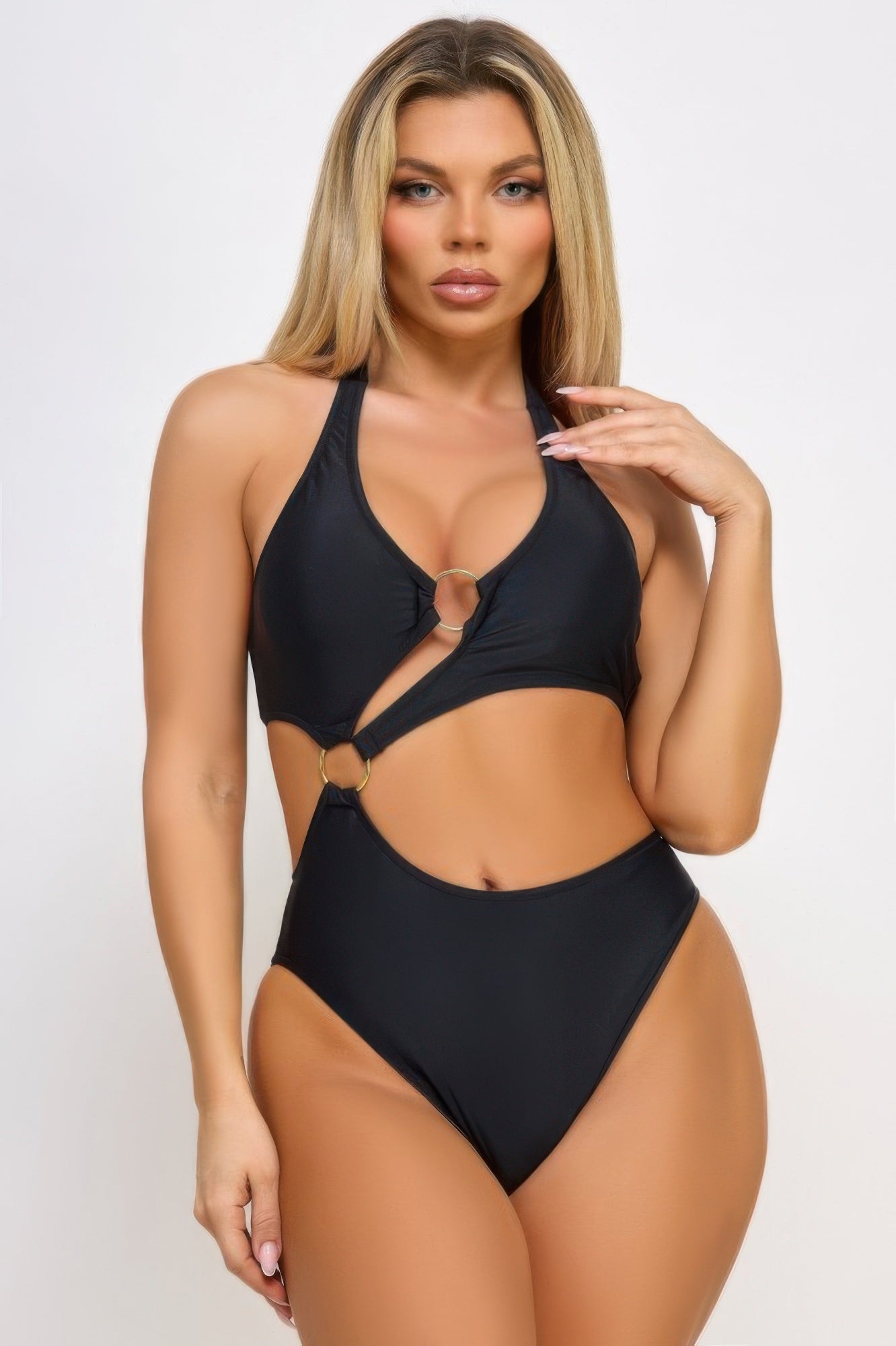 Model wearing CCWHOLESALECLOTHING cut out black one piece swimsuit with ring details halter neckline
