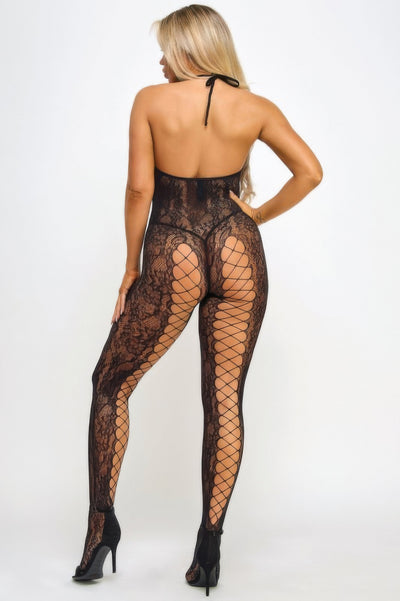 Back view of blonde model in black lace bodystocking for women with halter neck open back and fishnet legs