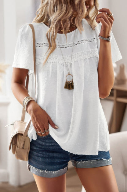plus size solid short sleeve top white textured lace yoke paired with denim shorts and layered necklace casual summer outfit