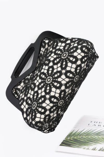 Black floral crochet wood frame clutch with white lining and cutout rectangular wooden handles