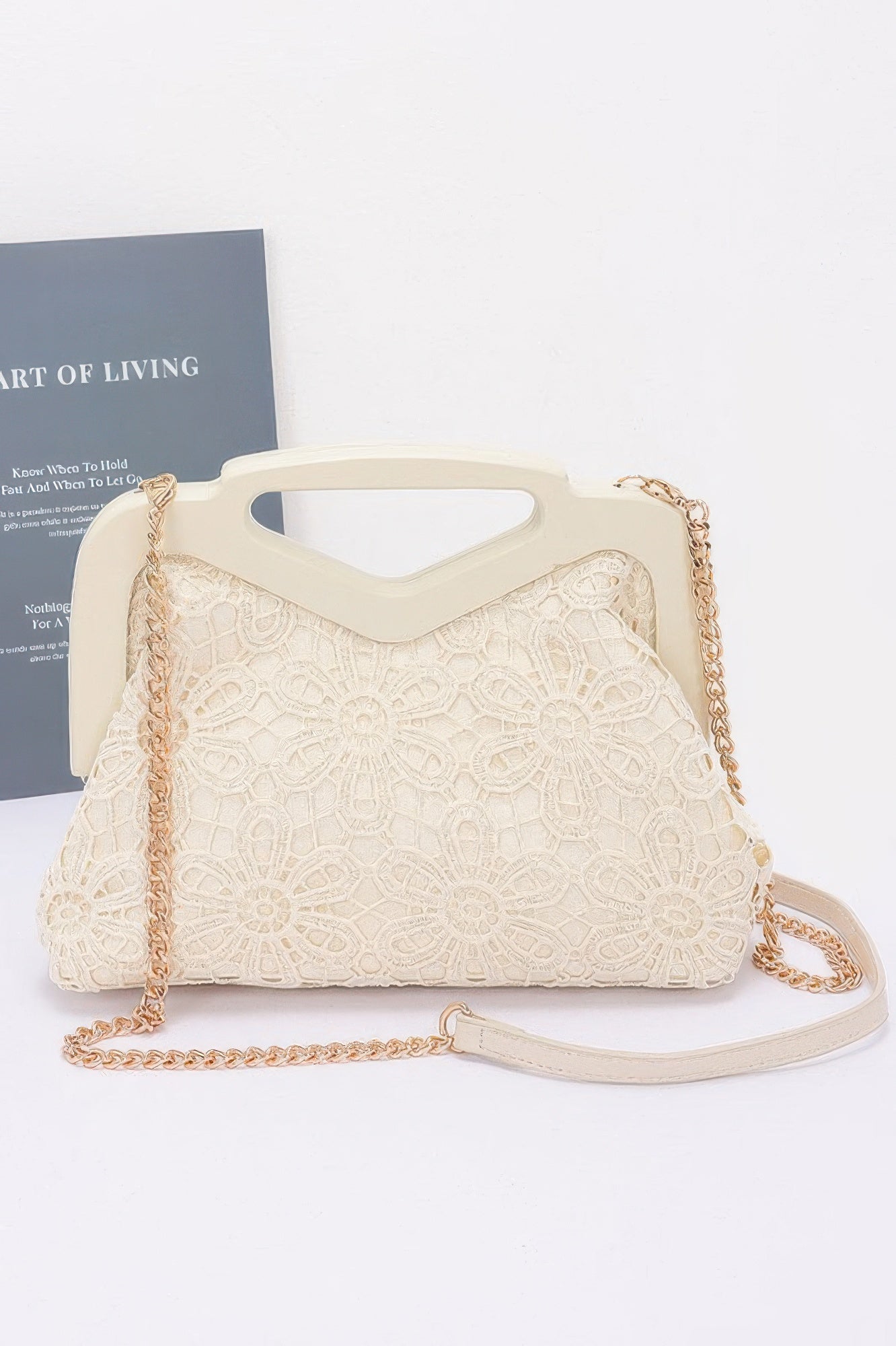 Cream crochet wood frame clutch with floral lace pattern and gold chain strap from CCWHOLESALECLOTHING