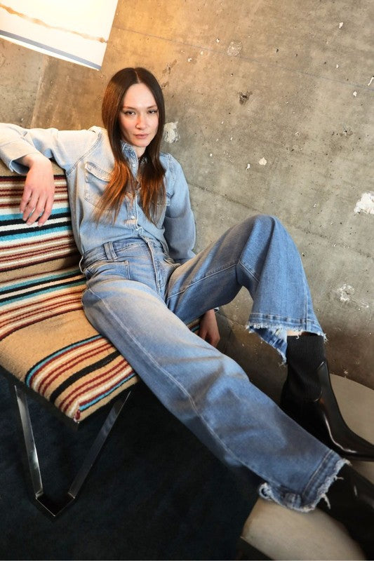 Artemis Vintage model wearing eco-friendly high rise palazzo jeans light wash with frayed hem and black boots