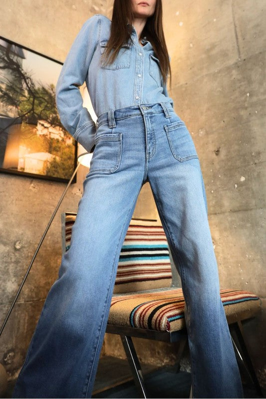 Artemis Vintage model wearing eco-friendly high rise palazzo jeans in light blue denim with wide legs