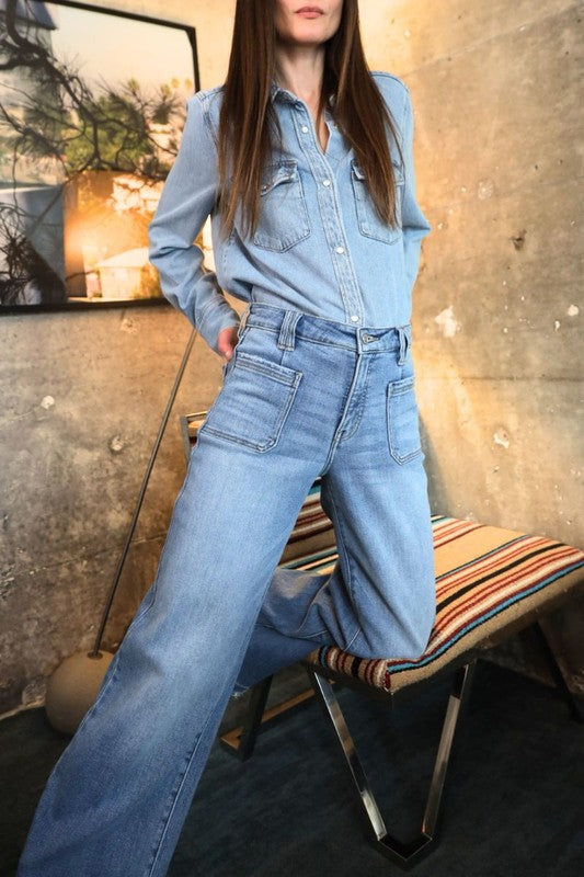 Artemis Vintage model wearing eco-friendly high rise palazzo jeans in light blue denim with utility pockets