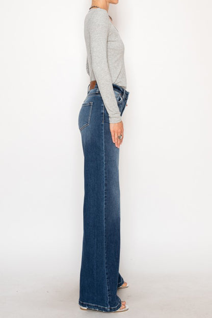 Artemis Vintage Relaxed Flared Jeans dark wash high waist side view on model wearing gray top