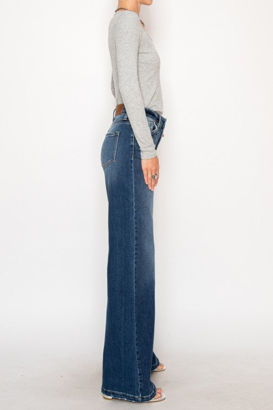 Artemis Vintage Relaxed Flared Jeans dark wash high waist side view on model wearing gray top