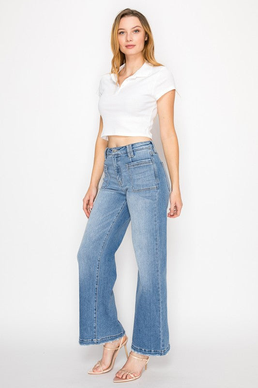Artemis Vintage model wearing women's eco-friendly palazzo jeans high waisted light wash wide leg