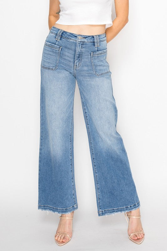 Artemis Vintage model wearing women's eco-friendly palazzo jeans high waist light wash wide leg raw hem
