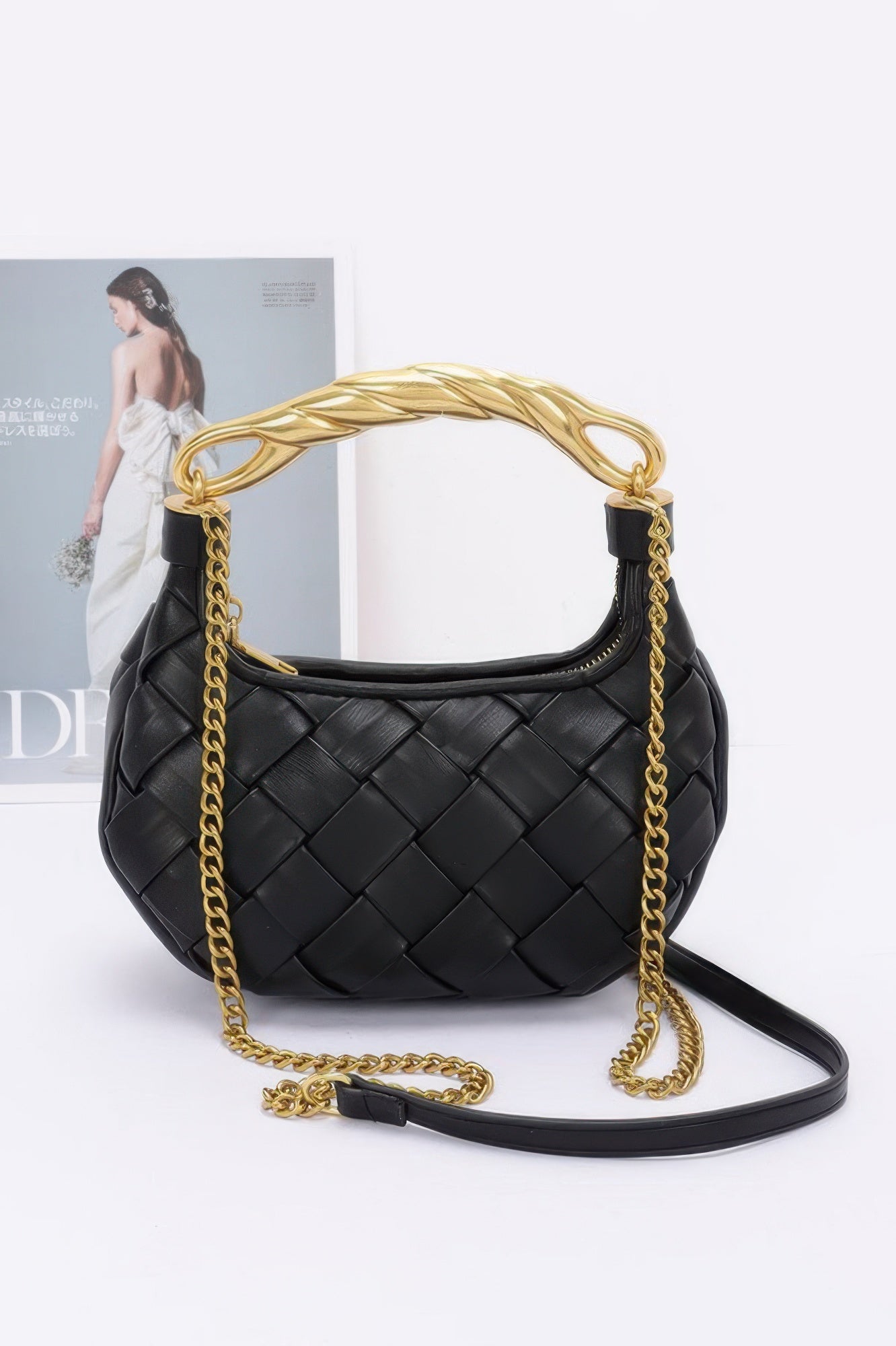Black woven crossbody faux leather braided handle bag with gold chain strap and twisted top handle