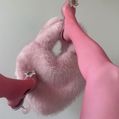 Trendsi pink furry Heart Messenger Bag shown with model wearing pink tights and jeweled heels
