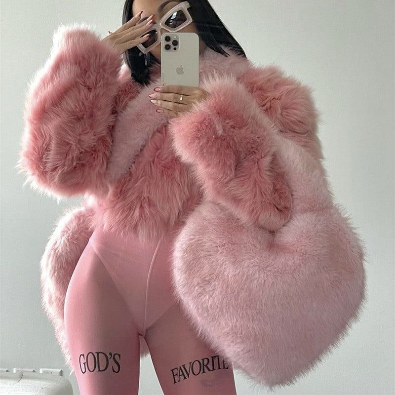Trendsi Heart Messenger Bag pink faux fur heart shaped shoulder bag styled with matching pink fur coat