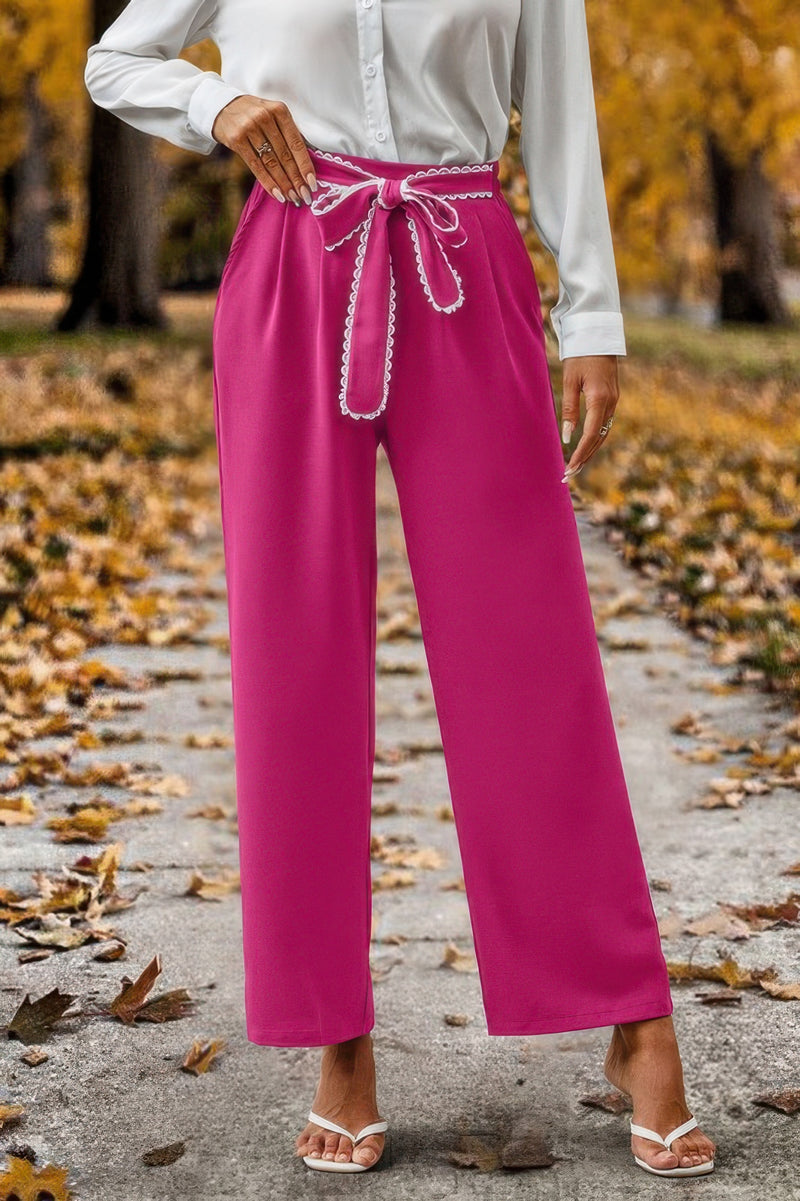 Magenta tie belt high waist straight leg pants for women with white blouse and sandals on autumn path