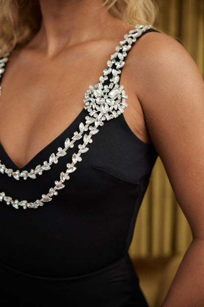 Black layered crystal strap bodysuit with jeweled V neck straps and decorative crystal chains on shoulder