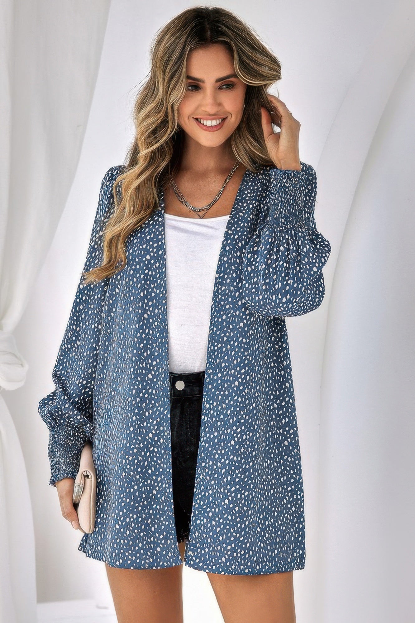 Woman wearing CCWHOLESALECLOTHING leopard print front open top in blue over white tee and shorts
