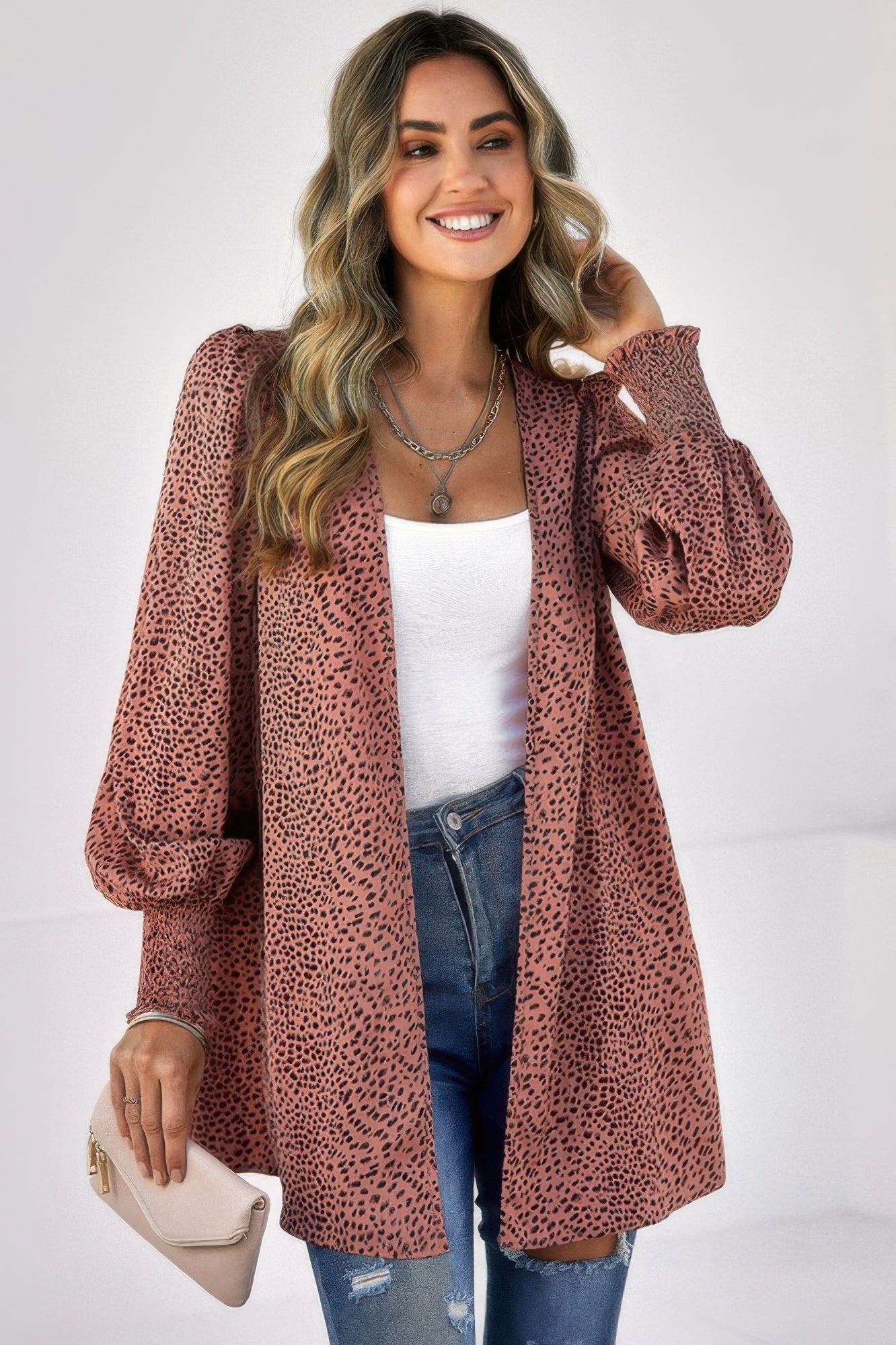 Woman wearing CCWHOLESALECLOTHING leopard print front open top rust pink balloon sleeves over white tank and jeans