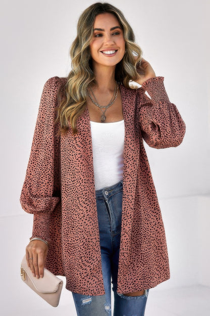 Woman wearing CCWHOLESALECLOTHING leopard print front open top rust pink balloon sleeves over white tank and jeans