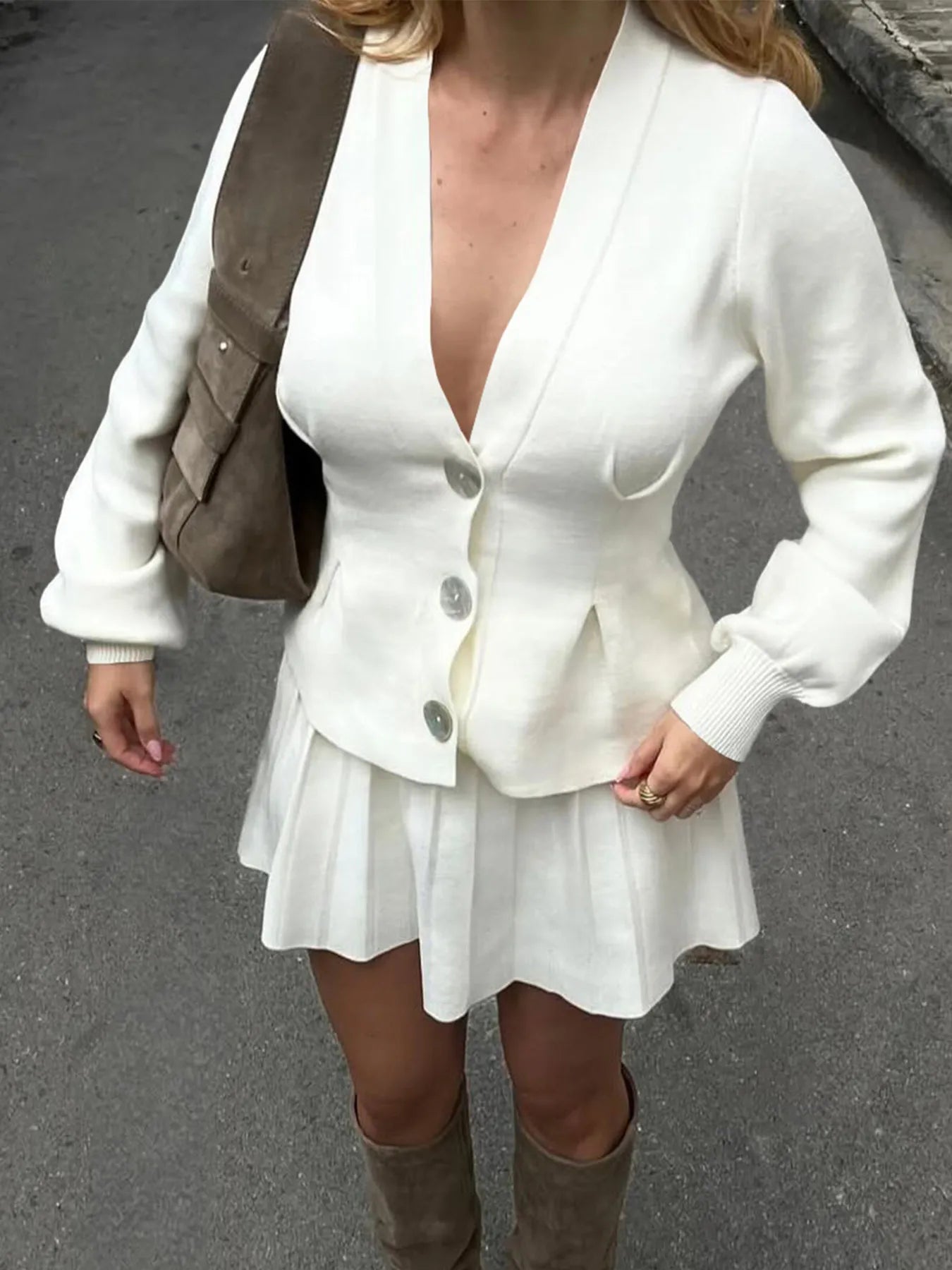 Trendsi women's button-up knit cardigan cream V neck with three buttons and pleated hem worn with mini skirt