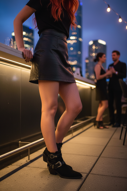 Black western ankle boots at urban rooftop bar