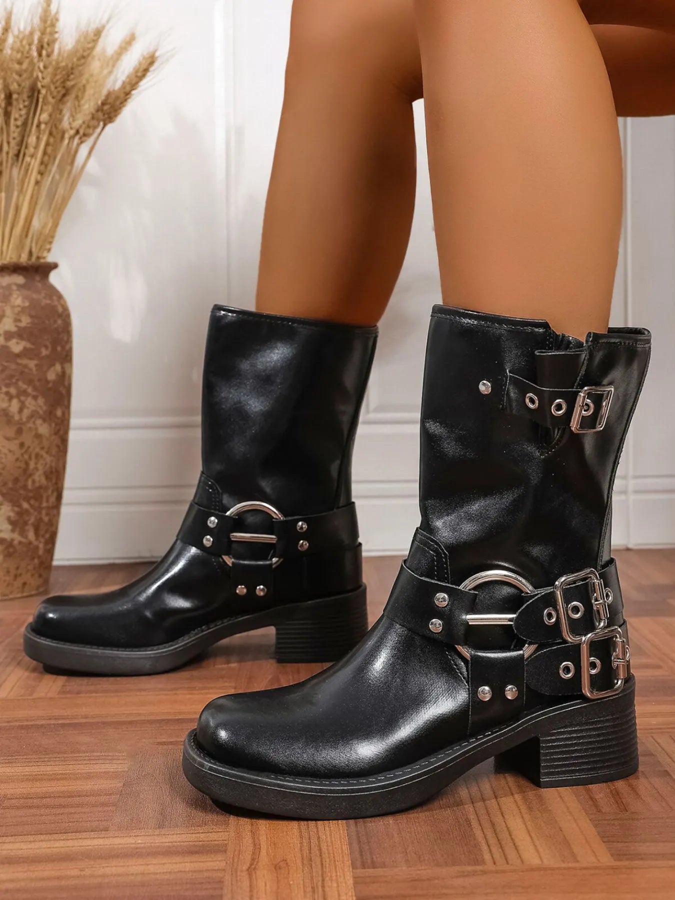 Trendsi black Block Heel Biker Boots with buckle straps and silver studs on wooden floor