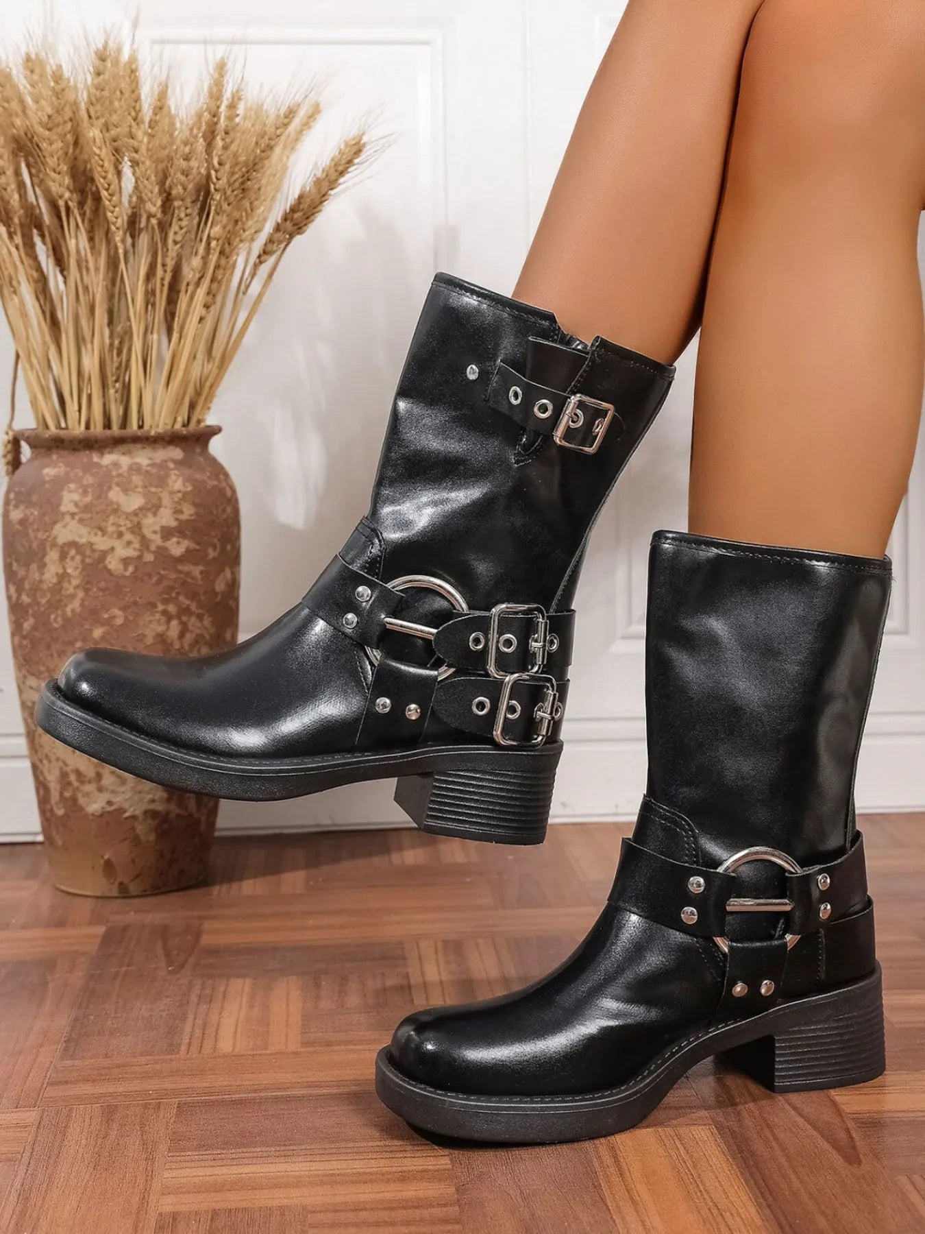 Trendsi black Block Heel Biker Boots with buckle details and sturdy chunky heels on wooden floor
