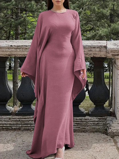 Trendsi bohemian maxi dress with cape sleeves in dusty rose with fitted bodice and flowing floor length skirt