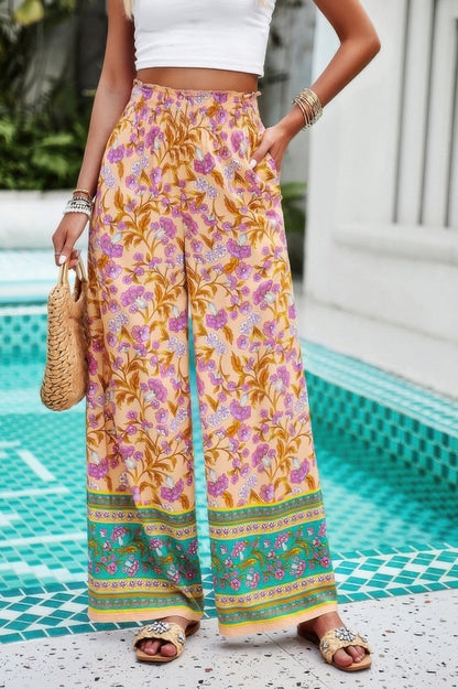 floral wide leg pants for women in yellow pink botanical print with elastic waist pockets and sandals