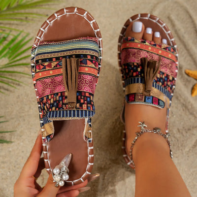 Trendsi Boho Tassel Slide Sandals with colorful patterned straps and brown tassel detail on sandy beach