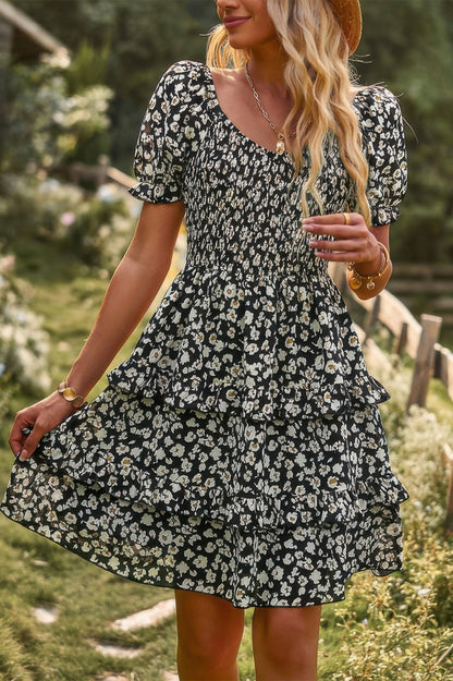 CCWHOLESALECLOTHING woman in floral print off shoulder dress black with white daisies smocked bodice and ruffle tiers
